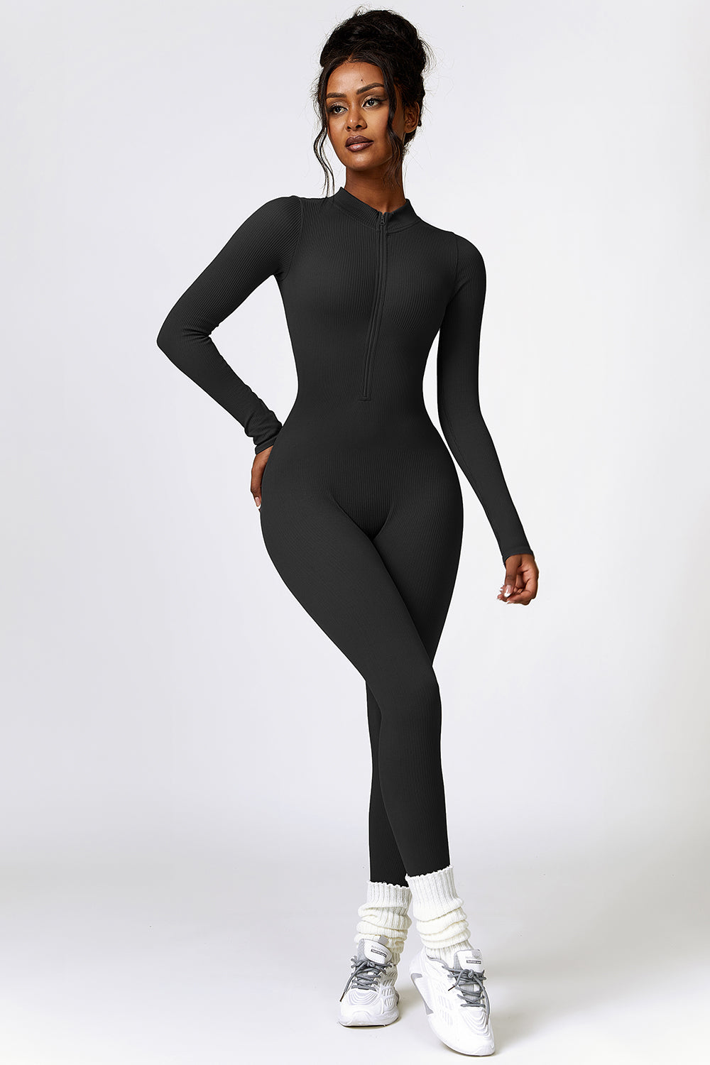 a woman in a black bodysuit posing for a picture