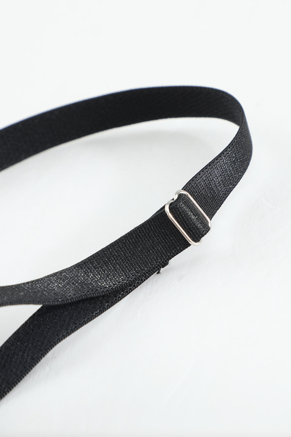 a close up of a black belt on a white surface