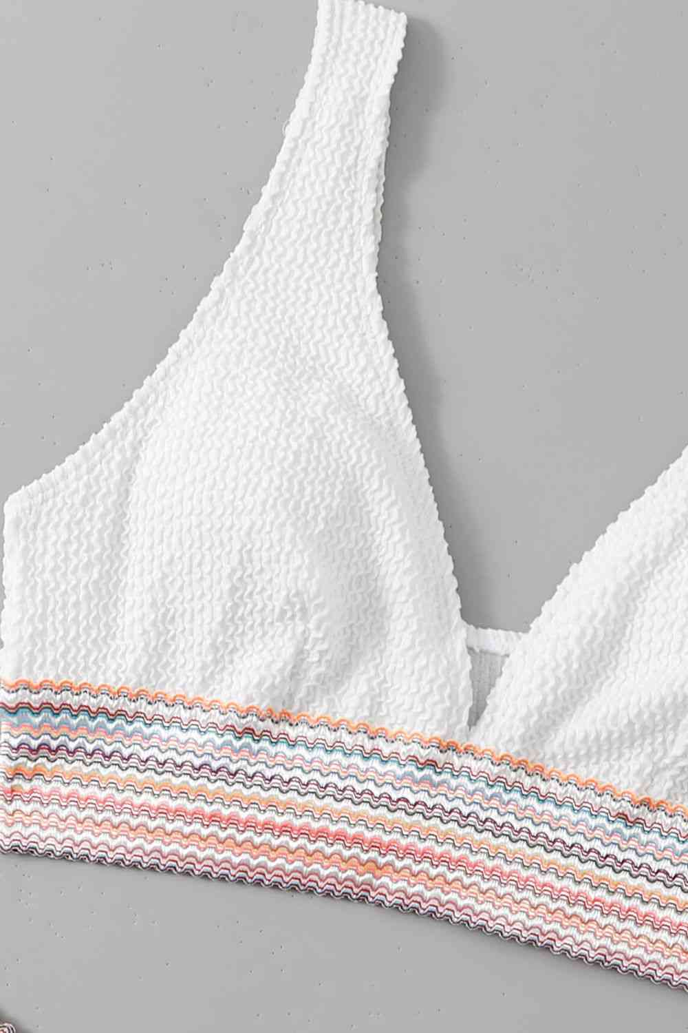 a white bra top with multicolored stripes