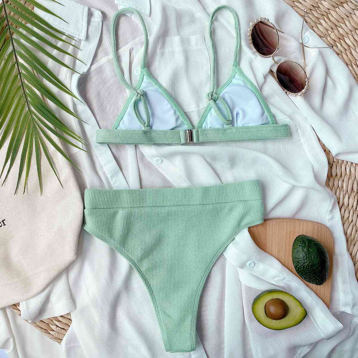 a woman's bikini top and panties with an avocado and sunglasses