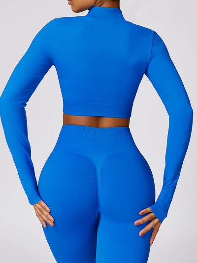 a woman in a blue outfit with her hands on her hips