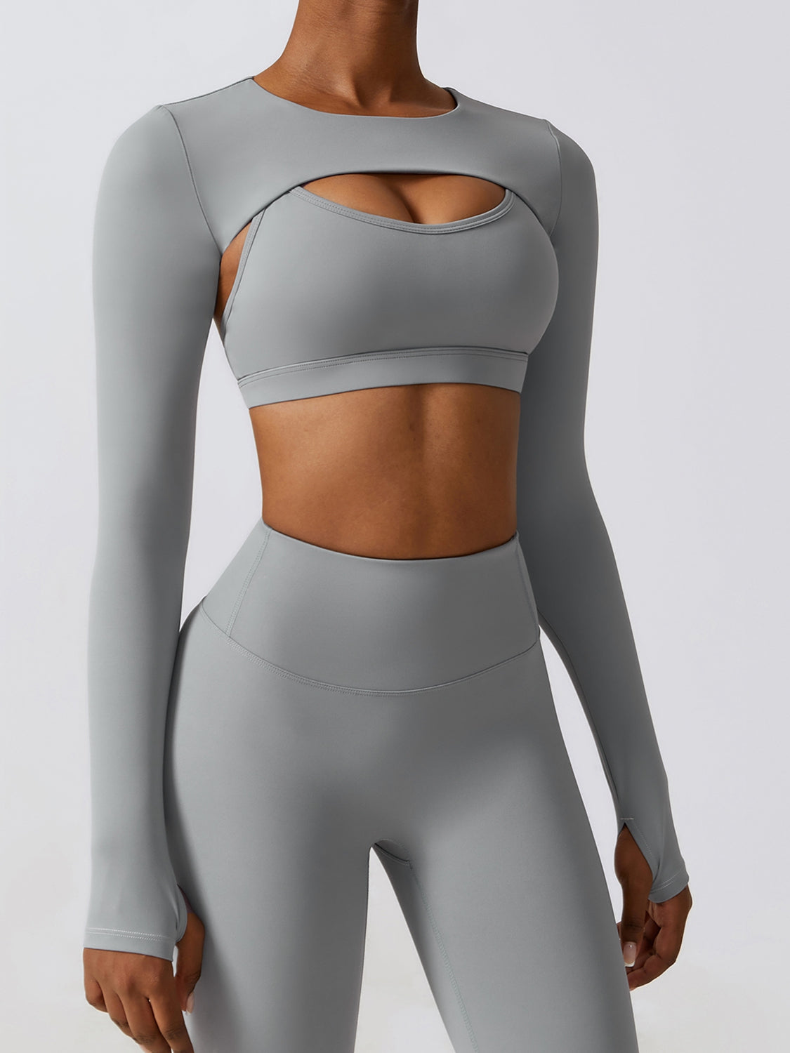 a woman in grey sports bra top and leggings