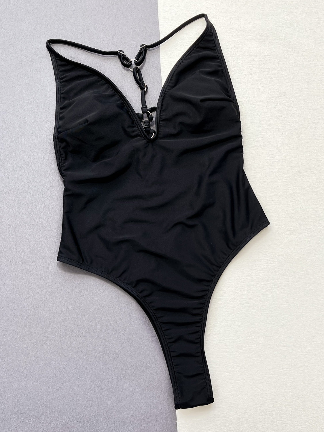a black one piece swimsuit with a halter