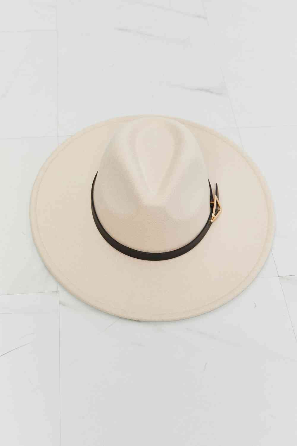 a white hat sitting on top of a white floor