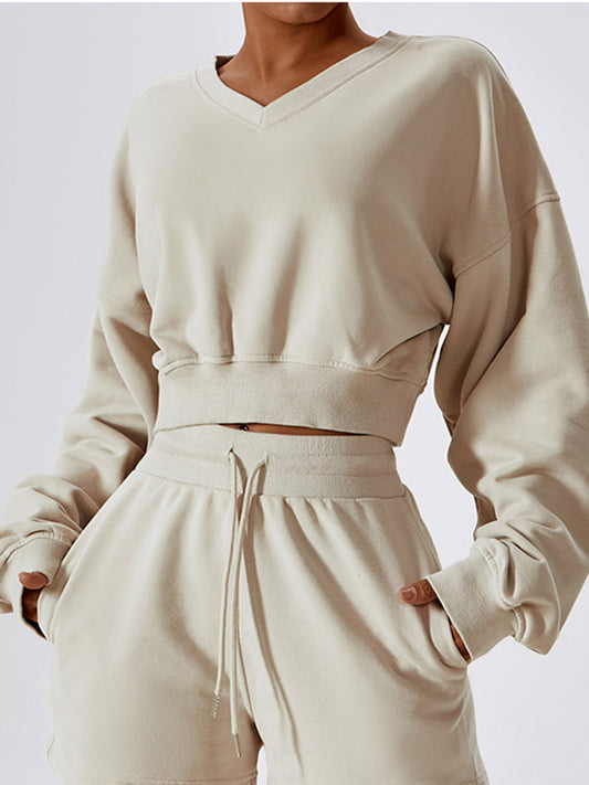 a woman in a white sweatshirt and shorts