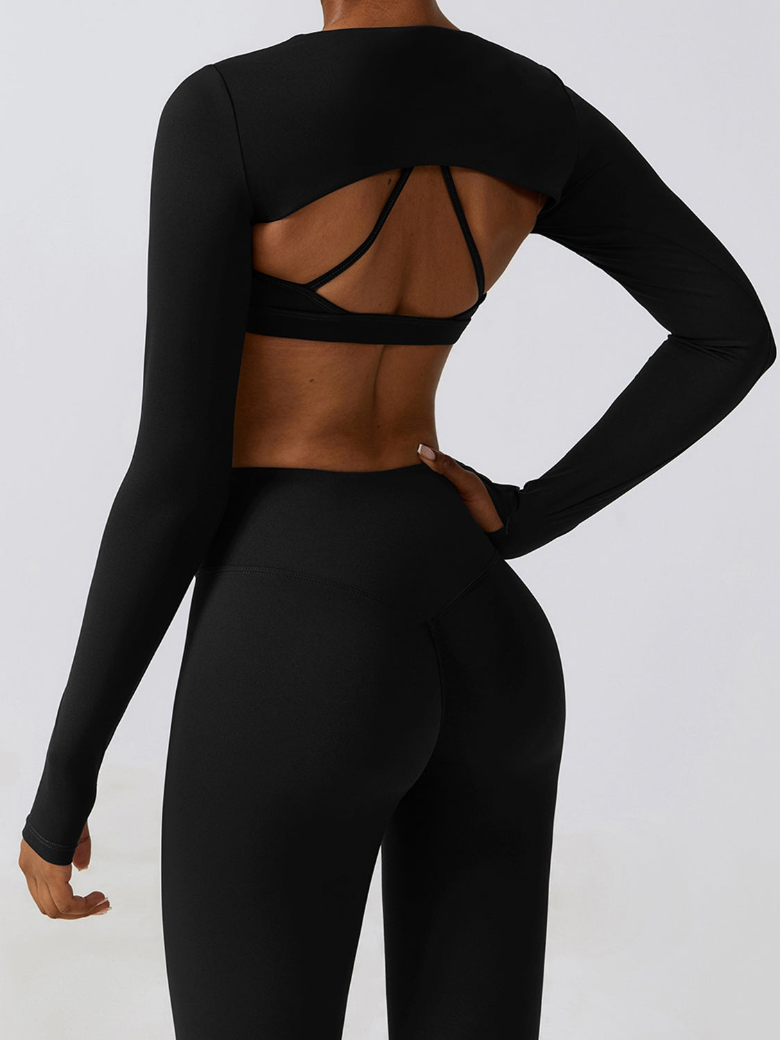 a woman in a black sports bra top and leggings