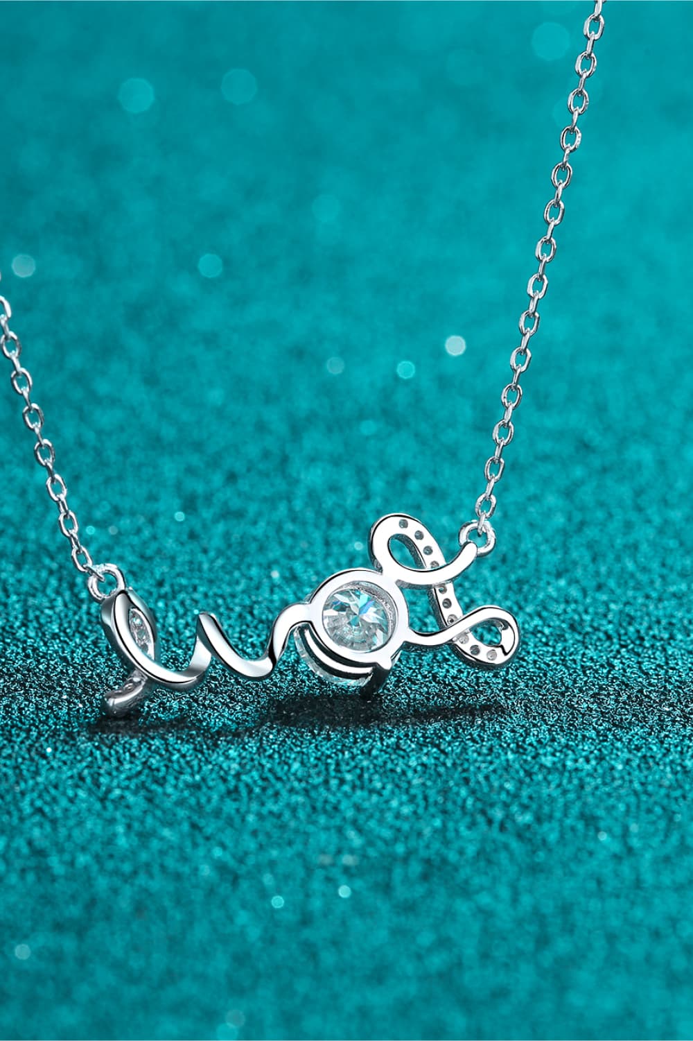 a silver necklace with the word love on it