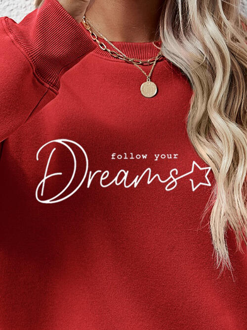 a woman wearing a red sweatshirt that says follow your dreams