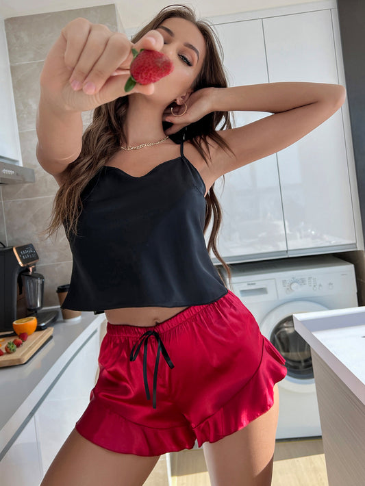 a woman standing in a kitchen holding a strawberry
