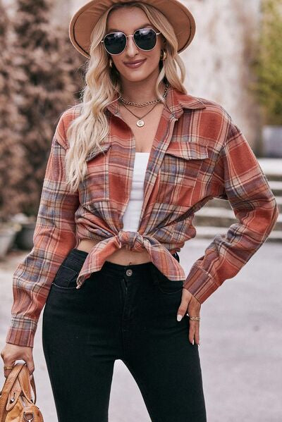 a woman wearing a plaid shirt and black jeans