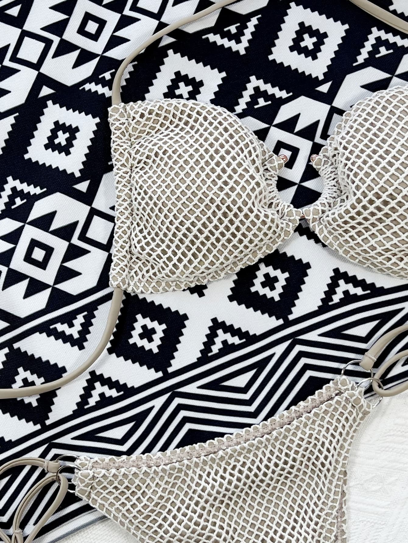 a pair of bras laying on top of a black and white rug