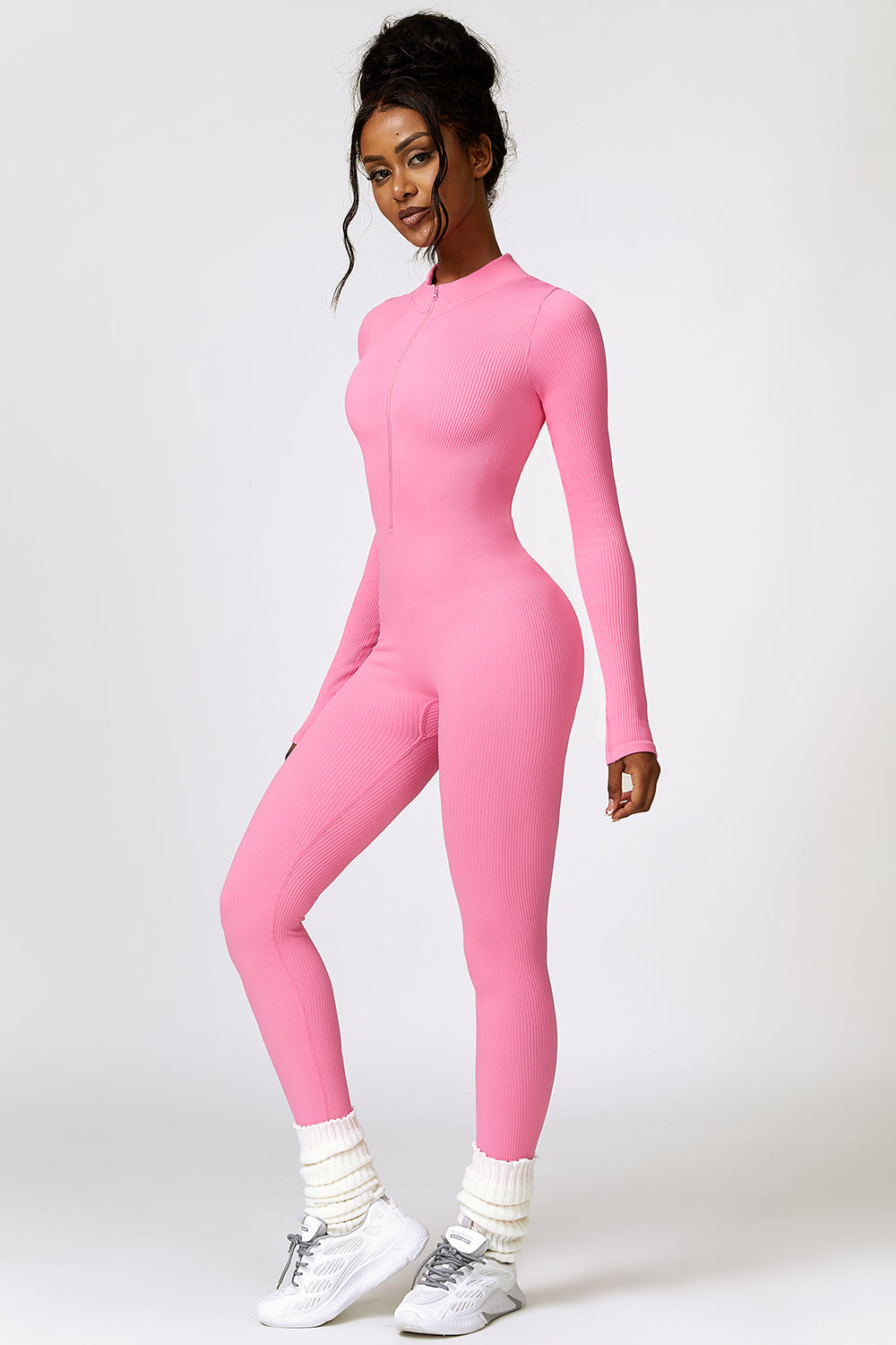 a woman in a pink bodysuit posing for a picture