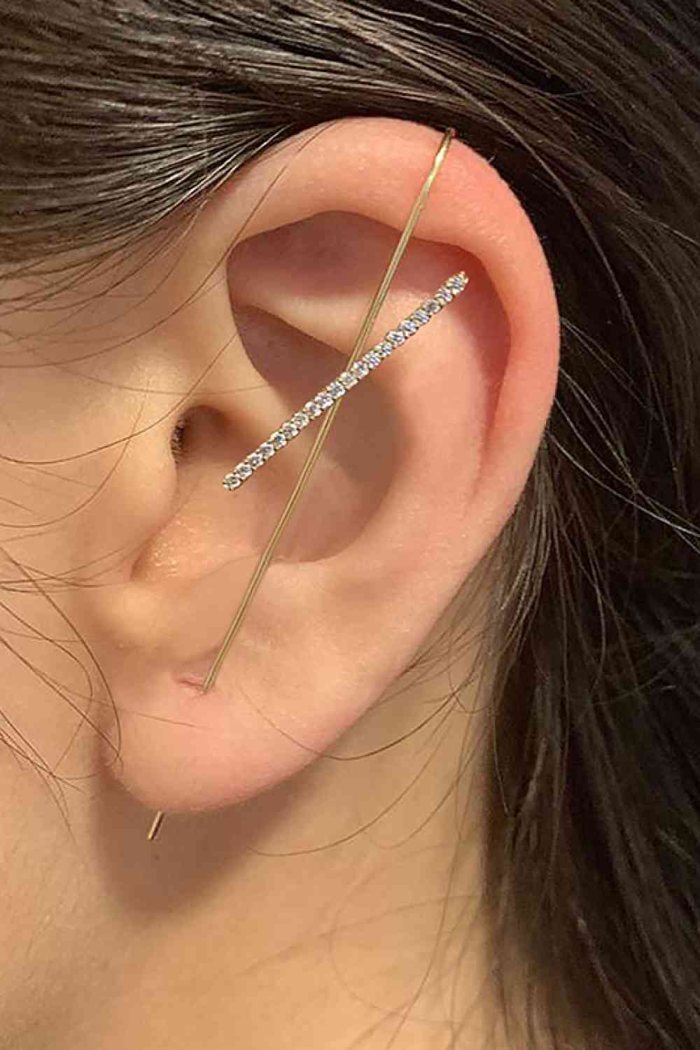 a close up of a person wearing a pair of ear piercings