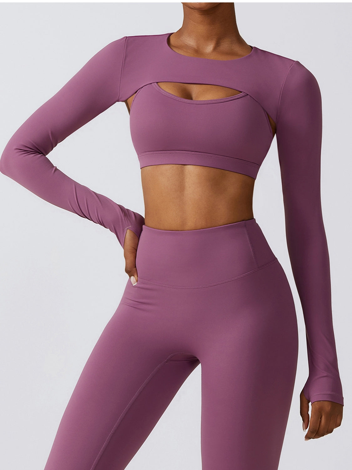 a woman in a purple sports bra top and leggings
